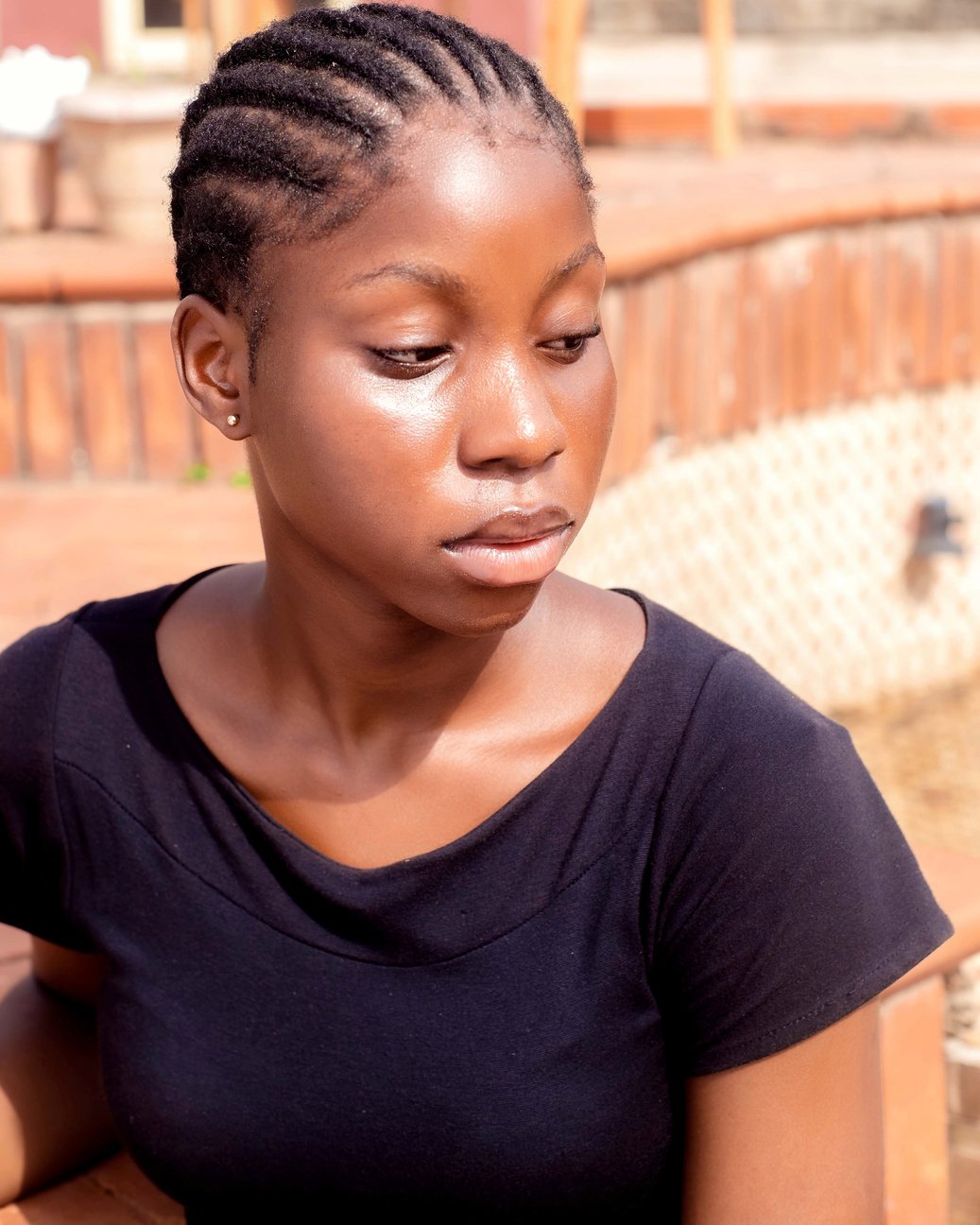 A Woman with a Cornrow Wearing a Black Shirt